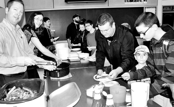 It took the involvement of many from the wider community to make the Welcome Back Pancake Breakfast such a success at the Canora Composite School on September 16. At left, Shannon Leson, a Good Spirit School Division board member, and Jacqueline Skurat, an educational assistant, served sausages and pancakes, while at right, Dorian Jones, a CCS student, was joined for breakfast by his father, Brendan, and his little brother, Teagan.