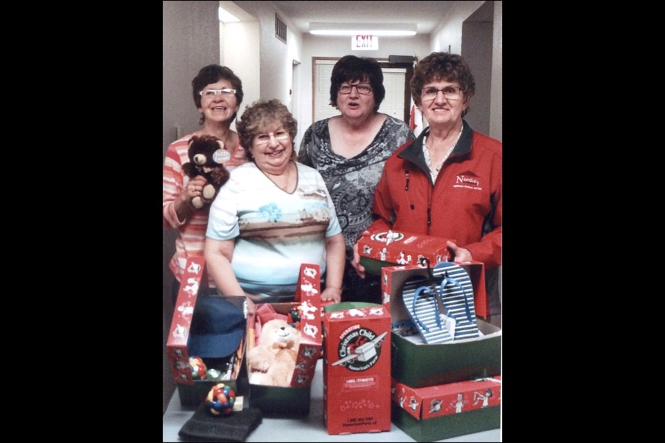 Mayfair’s Save a Third World Child Club executive members prepare show boxes for Third World Countries through Samaritan’s Purse. In the photo are: Elaine Woloshyn, Ruby Rafuse, Margaret Adam and Adgerine McNutt. The club was organized this past March and has donated a substantial amount to the less fortunate overseas. Photo submitted by Elaine Woloshyn