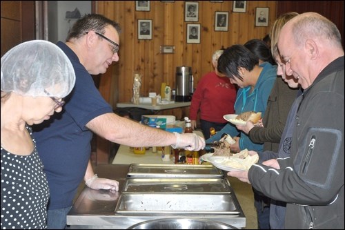 Stuffing the Stockings —  The Empty Stocking Fund launched its campaign in the Battlefords this past week with their annual beef on a bun event at the Third Avenue United Church. Volunteers were serving up beef for the large number of people who showed up over the noon hour Friday. Photos by John Cairns