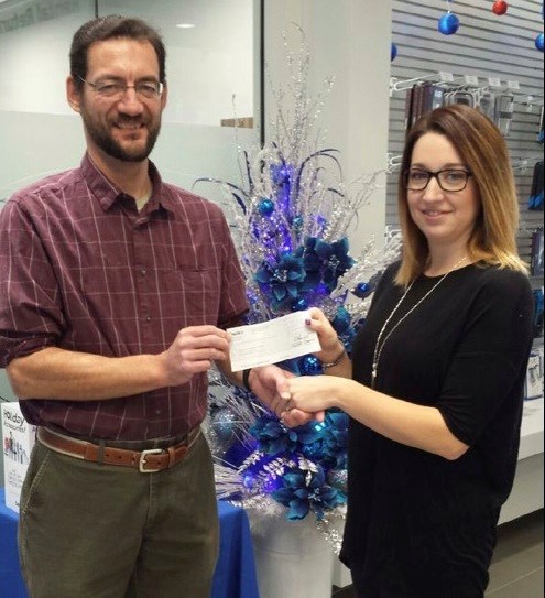 Humane Donation — SaskTel TelCare recently made donation of $1,602.41 towards care of animals. In the photo, Dr. Shawn Haas, president of Battlefords Humane Society, accepts a cheque from Jenna Russell of SaskTel. Through SaskTel’s TelCare program, established in 1950, SaskTel employees donate funds through payroll deduction. The corporation matches that amount and the funds are distributed to Saskatchewan community groups. North Battleford and District TelCare donated $16,570 to eight organizations in 2014. Photo submitted