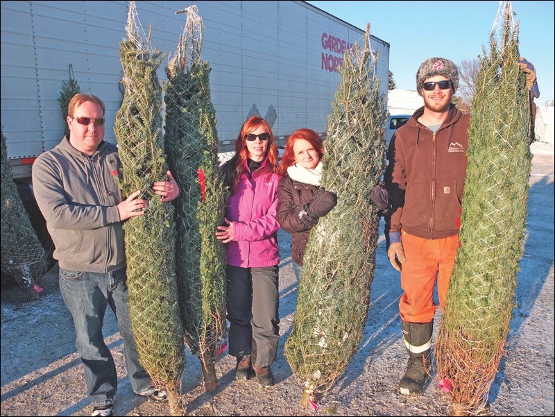 Flin Flon Kinsmen and Kinettes held their Christmas tree sale in the Gateway Convenience Store parking lot last Saturday, Nov. 28. Among those helping out were Tim Babcock (from left), Michelle Taylor, Marlene Gogal and Paul Harrison. The clubs sold 178 trees grown by a company outside of Prince Albert. Tree buyers received a discount if they brought a non-perishable food item for the Lord’s Bounty Food Bank. The clubs will be donating cash and the food to Lord’s Bounty in time for Christmas.