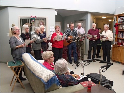 Borden Friendship Club singers at Borden Care Home tea Dec. 4, singing carols. In  the group are Brenda Tumbach, Brenda Roberts, Helen Sutherland, Laura Loeppky, Eileen Petrun, Ed Neufeld playing guitar, Archie Wainwright, Ruben Rempel and Wendell Dyck.