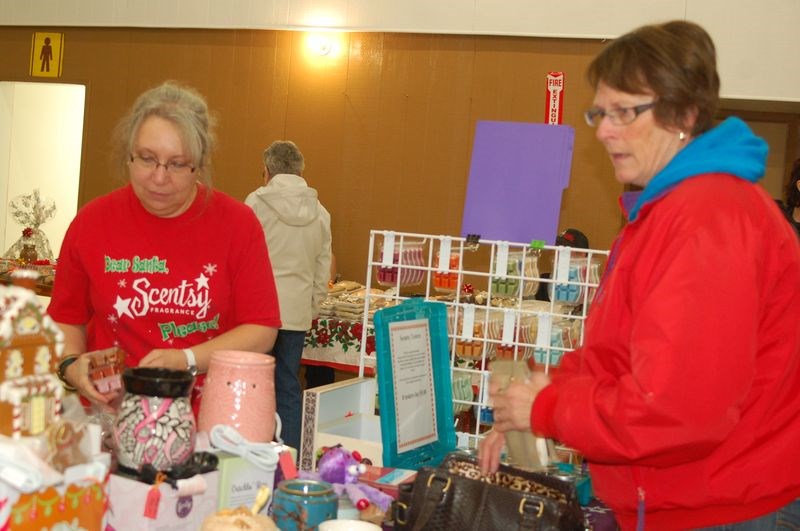 Janet Roelens showed some candles and scent products from the Scentsy line to Nancy Chorneyko at the annual Preeceville Christmas craft sale on December 5.