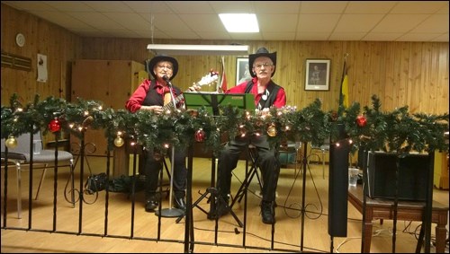 Nancy and Orton Ratzlaff entertaining at the Borden Friendship Club Christmas supper Dec. 8 .