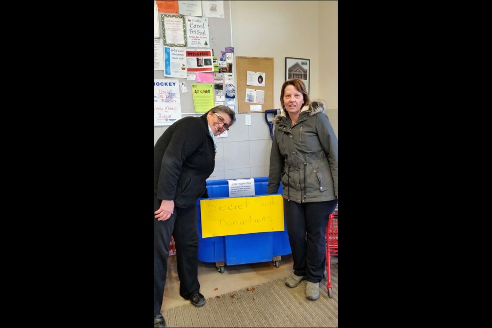 Secret Santa committee chairs, Bea Stephenson and Sharon Riou, spent many hours collecting items dropped off at the Secret Santa bins around town preparing for the annual Secret Santa assembly and delivery night Dec. 21. Photos by Sherri Solomko