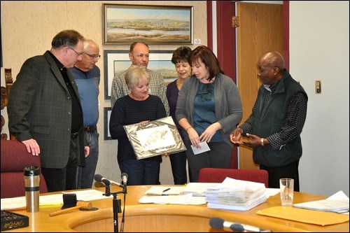 The Historic Battleford Lions Club presented a cheque for $2,375 to go toward re-opening the Opera House and a piece of art work to the Town of Battleford Dec. 21. Left to right are Mahor Derek Mahon, Lions Doug and Audrey Reid, Neil and Rhonda Gosling and Suzanne Reid and the Town's representative on the Opera House board, Councillor Gordon Yarde.