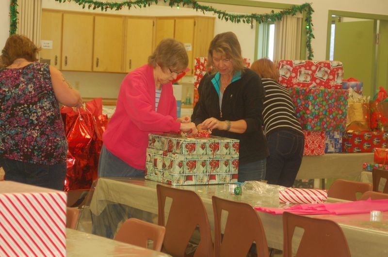 Evelyn Reagan and Elaine Meachem were among the many volunteers who helped wrap for the Filling the Gap Christmas food hampers and Christmas gifts projects. The volunteers wrapped more than 78 gifts at the Grace United Church in Sturgis on December 15.