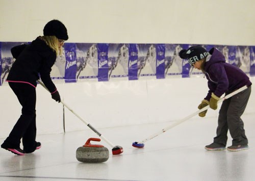 Jaydee Drumm and Rory Greenbank sweep a rock down the ice during the Wawota Curling Club’s clinic with CurlSask on Saturday, Jan. 9.