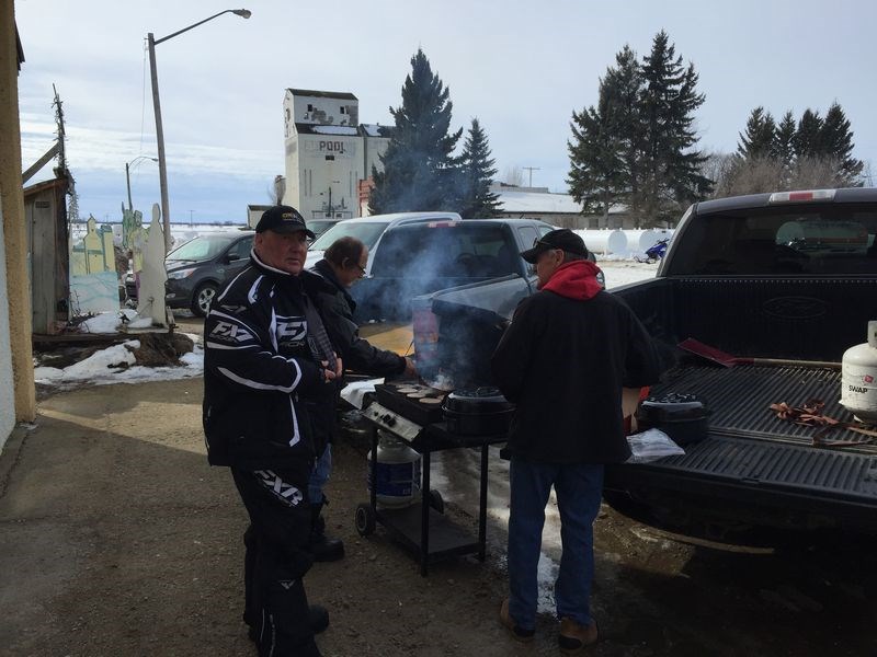 Larry Zbeetnoff of Kamsack was cooking burgers at Veregin on March 12 during the 32nd annual Tolstoi Poker Derby held by members of the Kamsack Sno-Drifters. With Zbeetnoff were Dale Rauckman, left, and Doug Ducheminsky.