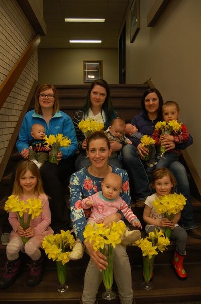 Four employees at the Kamsack branch of Affinity Credit Union who are mothers, assembled on Friday with their children and with the bouquets of daffodils which were purchased from the Kamsack Eastern Star to raise money for the Canadian Cancer Society. Involved in the spring-themed photograph, from left, were: (top row) Kyra Chorneyko holding her son Owen Rudy, Crissy Bielecki holding her son Avery, and Lindsey Matechuk with her sons Conner and Levi, and (front) Jade Sas, Jodi Sas holding her daughter Piper and Layla Sas.