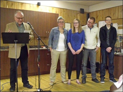 Pat Dergousoff from the Mennonite Brethren conference gives a prayer of blessing for the Martens family, Michelle, McKinley, Tony and Zach.