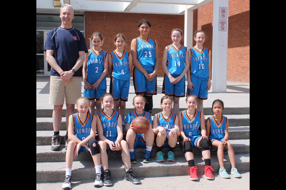 The Estevan Thunder Grade 6 girls club basketball team, with back row from left, coach Kevin Kobitz, Josie Andrist, Alex Andrist, Yasmine Tyndell, Emily Phillips, Lauren Kobitz; front, Katie Milbrandt, Brianna Nykiforuk, Reese Madsen, Kiera Phillips, Kamila Jedrzejowska and Hyezel Montebon, recently won the Regina Heat basketball club GYGO tournament. Submitted photo.