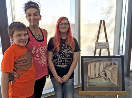 Keira Lewis-Fauth, grand prize winner of the upper elementary category of the Notre Dame School spring art contest, along with her family at the Dekker Centre where her work was featured in the lobby last week. Photo submitted