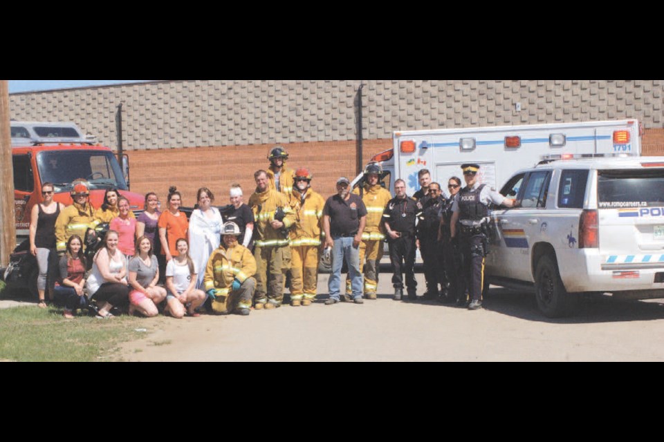 The Sturgis Chapter of SADD, along with members who represented the Sturgis fire department, Preeceville Ambulance and Canora-Sturgis RCMP, participated in a mock accident on May 17. From left, were: (back row) Dana Tureski, Shawn Howard, Farrah Howard, Rhianna Olson, Tessa Rehaluk, Sierra Meroniuk, Kaeleigh Folk, Brooke Olson, Greg Olson, Ryan Coleman, Eugene Boychuk, Ron Descalchuk, Steven Kardynal, Mark Bourassa, Jordan Taylor, Rogin Karckal-Roy, Cst. Andrea Cumby and Cst. J. Van Brugge; and (front) Allison Sopel, Nicole Tureski, Kristiaan Rayner, Peyton Secundiak and Brad Secundiak, fire chief.