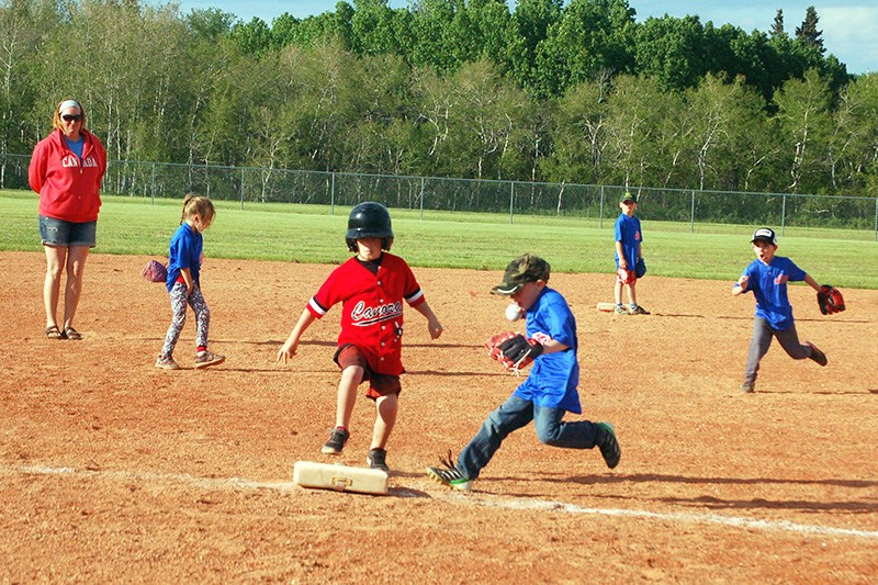 Wyatt Scheller of the Preeceville rookie ball team ran for third base to tag out a Canora player during a home game on June 1.