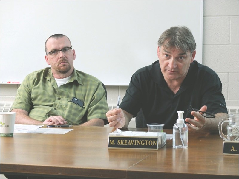 Trustee Murray Skeavington (right), chairman of the Flin Flon school board, answers a question during the unveiling of the board’s strategic plan. Looking on is Trustee Andy Burbidge.