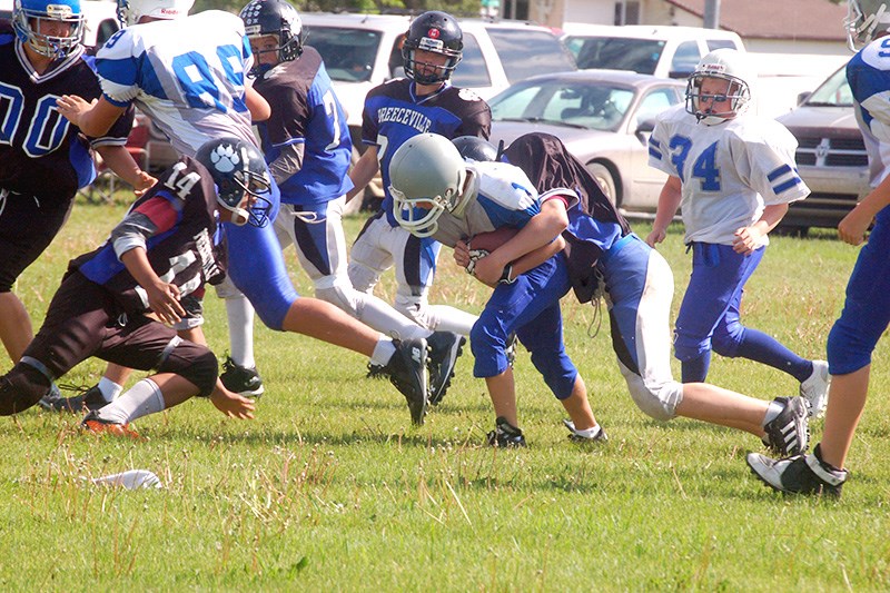 Preeceville peewee football players, who teamed up in a home game on June 14, from left, were: Jesse Prestie, Dweight Paligan, Shelby Wallin and Brenden Babichuk.