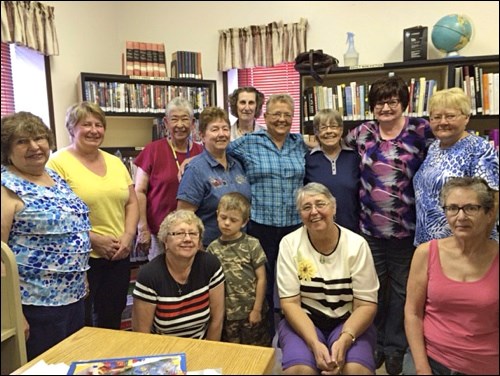 Janette Shepheard, Elaine Woloshyn's pen pal of 52 years, visited Mayfair Library June 14. In the photo are: back row – Adgerine McNutt, librarian Teresa Toews, Sally Salisbury, Ellyn Scotton, Valerie Taylor, Alice Grigor,  Shirley Lamontagne, Margaret Adam, Darlene Woloshyn; front row – Leanne Cherwinski with grandson Daxton, Janette Shepheard and Joanne Strain.