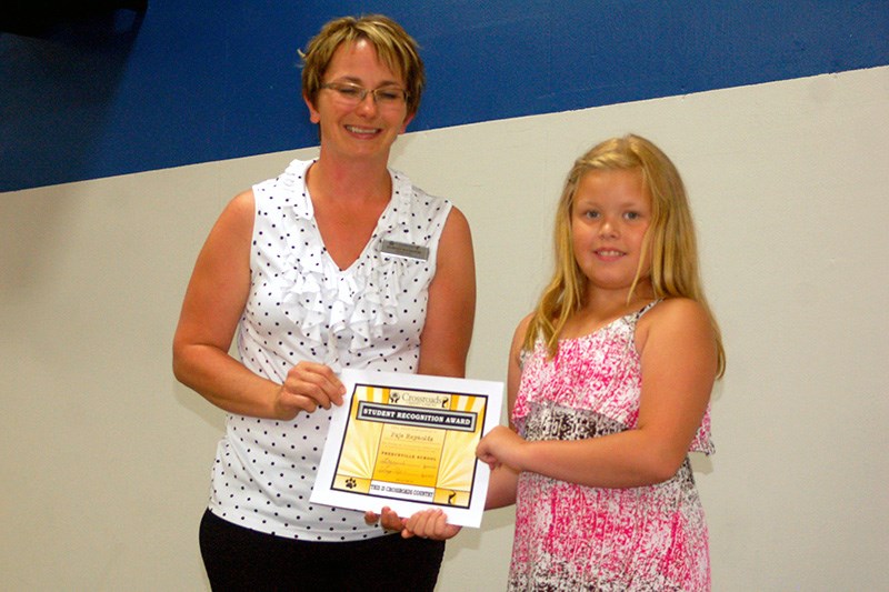 Doreen Bochnuik, representative from the Crossroads Credit Union, presented Paje Reynolds with a student recognition award during the Preeceville Elementary School awards.