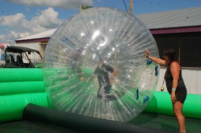 Andrea Tonn held the giant ball for Mason Bilan and Hudsyn Nelson to climb into one of the giant inflatable balls.