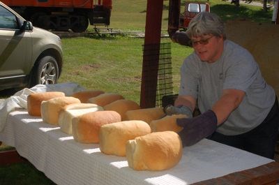 Cheryl Walker displayed the freshly baked bread from the out door clay oven at the Sturgis Station House Museum.