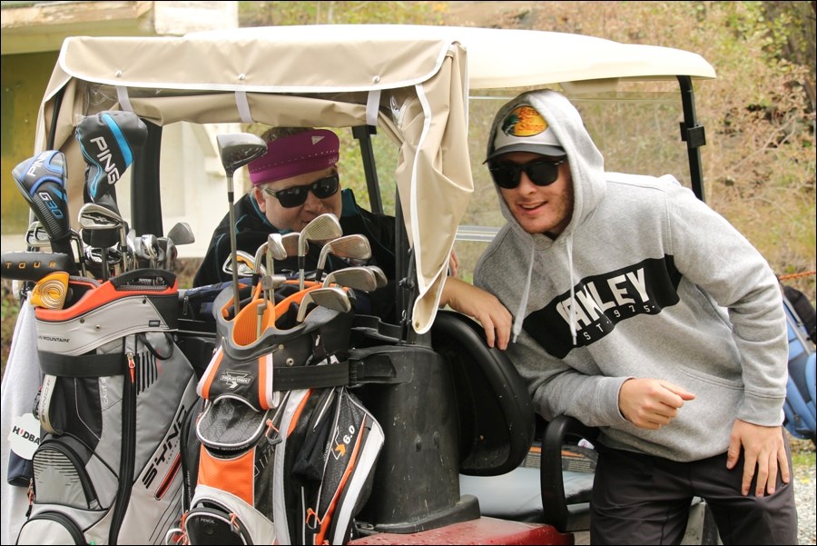 Looking cool in shades, Kelly Mansell (left) and Bombers captain Braden Lacoursiere pose for a pic on the links.