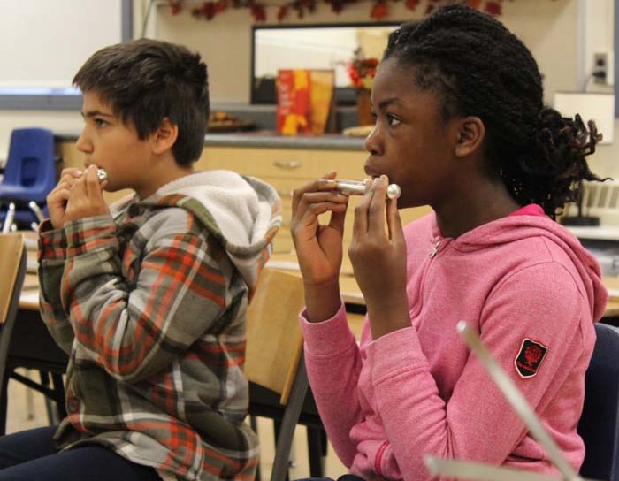 Beginning flautists learn proper tone hole techniques.