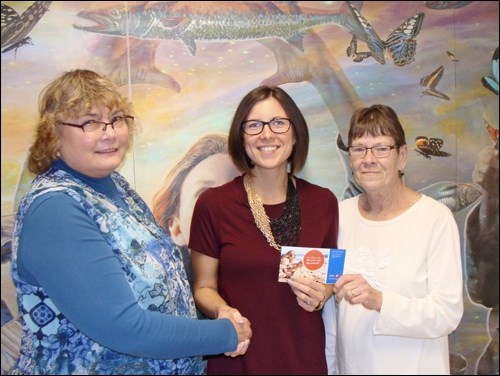 Support for Boys and Girls — Club 55 Plus bowling president Leslie McFarlane, and secretary Joyce Ruzesky present Nicole Combres, director  of the Battlefords Boys and Girls club with a donation. The club voted to give remaining funds to the organization. Photo submitted