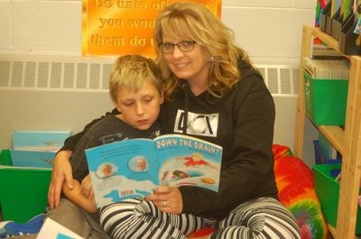 Candace Kuta read a story to her son Riley Kuta.