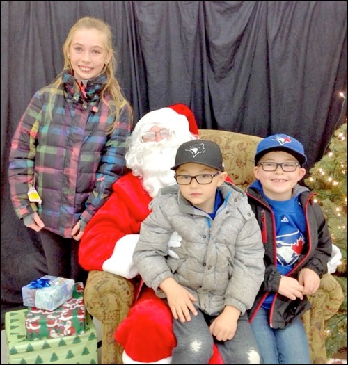 ADRA held their annual Santa Claus Day in the Meota Community Complex on Dec. 3 when over 100 folks turned out to take part and enjoy. Santa poses with Delaine, Beckett and Kannon Roger. Photos by Lorna Pearson