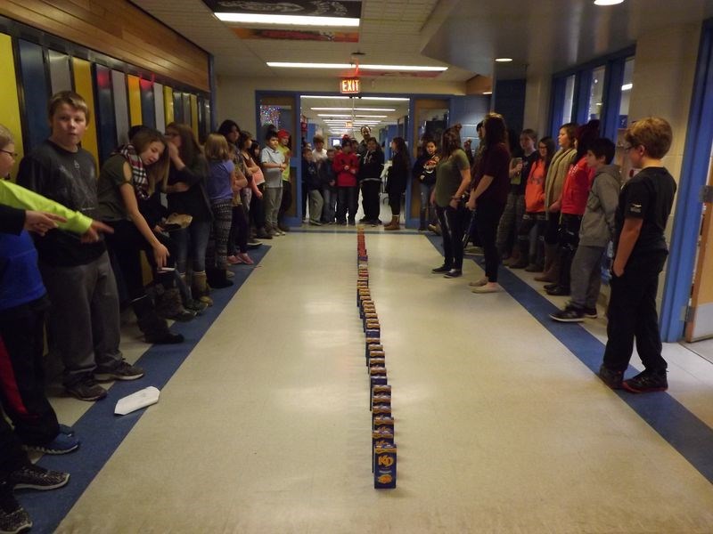 As another way to help fill the Christmas hampers at the Kamsack Comprehensive Institute, students were asked to bring boxes of “mac and cheese” to school one day last week. In total about 50 boxes were brought into the school. Because of the boxes’ resemblance to oversized dominoes, the temptation was too great not to line them all up like dominoes, push the first one over and watch as each box in turn knocked the next box down.