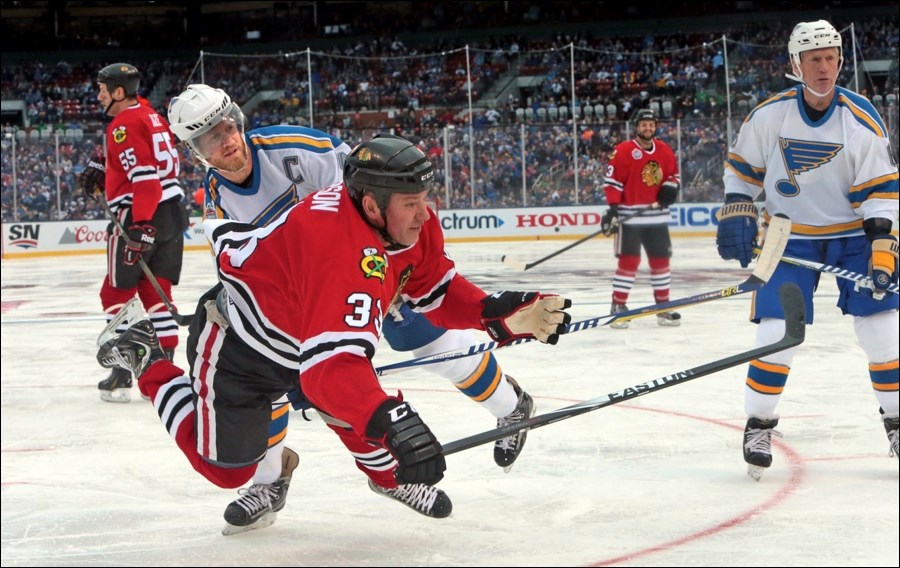 Flin Flon native and Chicago Blackhawks alumni team member Reid Simpson is upended by St. Louis Blues alumni captain Chris Pronger during last week’s contest in St. Louis. Simpson scored a goal in a losing cause.