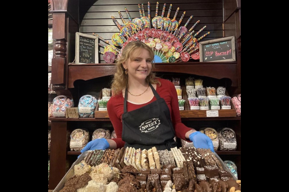 A staff member holding a platter of goodies at The Banff Sweet Shoppe in Banff, Alberta / The Banff Sweet Shoppe