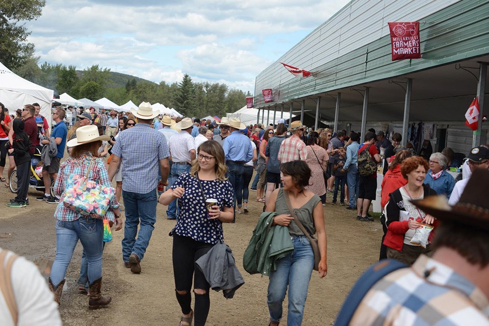 A large group of market-goers explore the farmers’ market in Millarville, Alberta / Millarville Racing & Agricultural Society