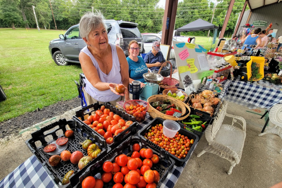 Suzanne Bailey owner of Sandy Creek Farm services up a side of smiles with locally grown produce