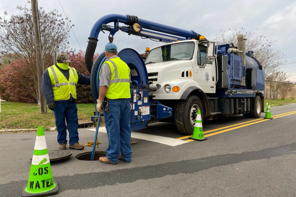 city-employees-inspecting-sewer-main