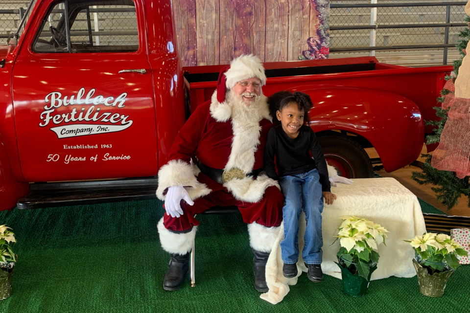 Santa came to town with the help of Four Points Santa, and Anderson’s General Store and Bulloch Fertilizer provided a red antique truck for him. 