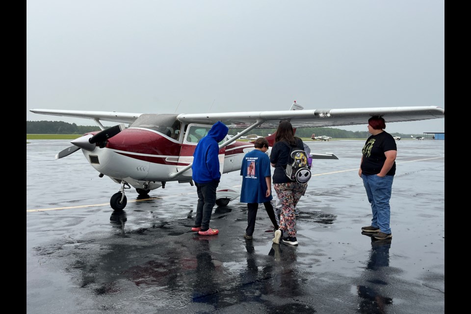 Students after their first flight, talking to the pilot