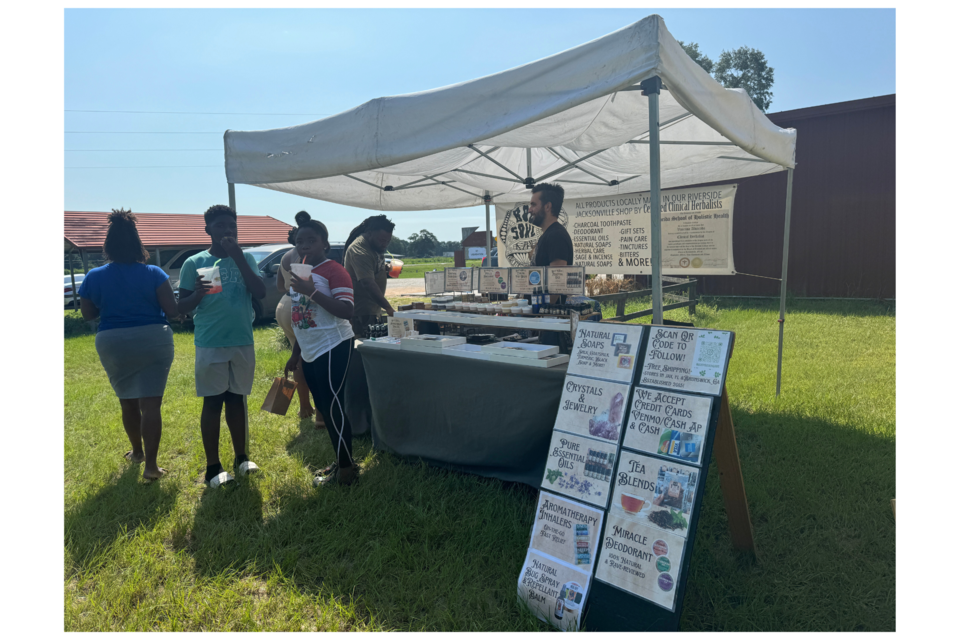 Body & Soul Statesboro owner AJ Copeland talks with customers at the outdoor market. 