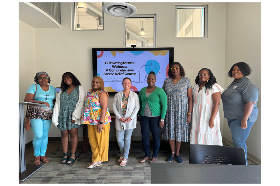 Jade Humphries poses with some of the attendees after a successful presentation. 