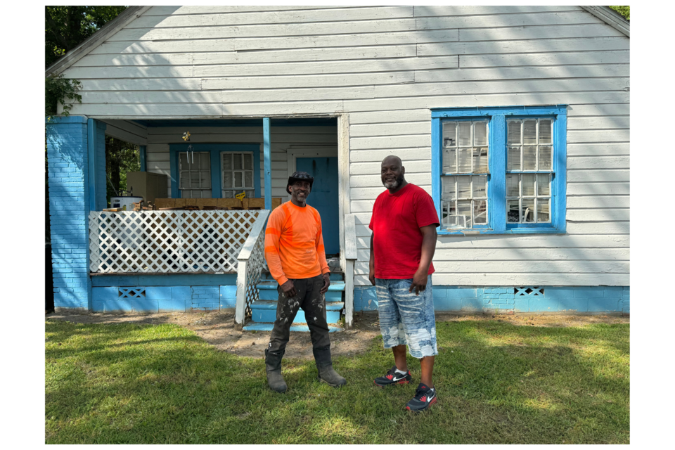 Leroy Lipsey and Maurice Brack stand in front of Lipsey's childhood home which now serves as Division One's shop. 