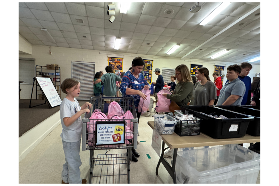 Volunteers brought the Christmas cheer to The Button's Christmas holiday hygiene bag prep party.