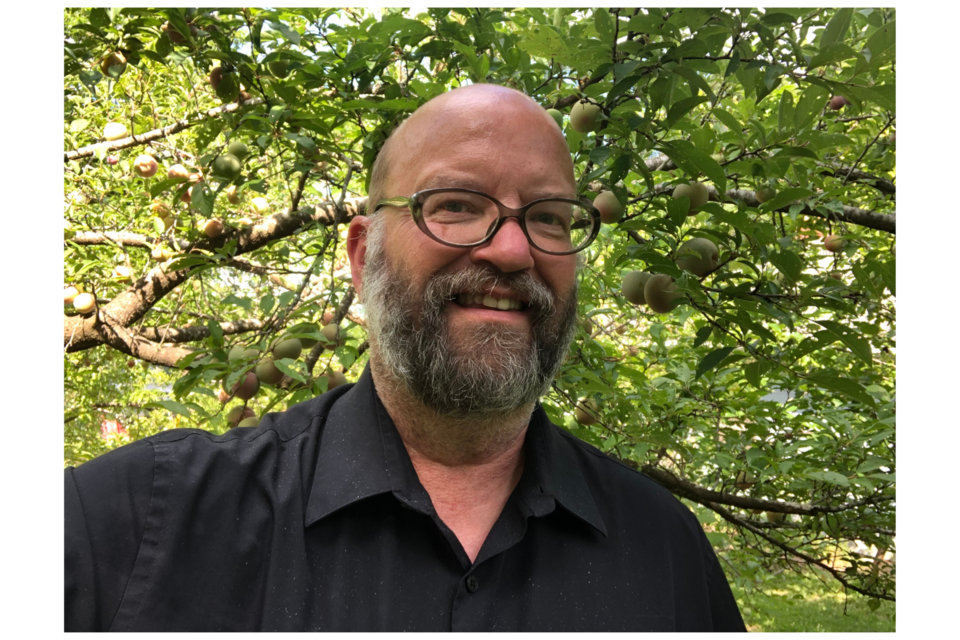 Marcus Toole, the man who made plums his pastime, standing in front of his Marianna 2624 plum tree.