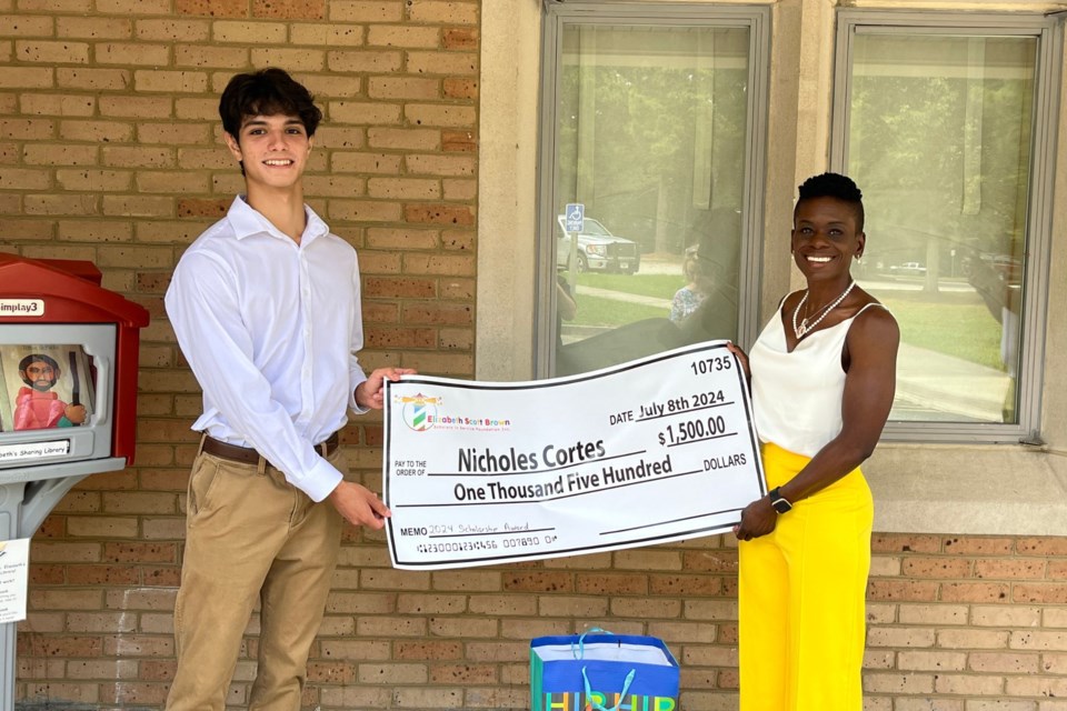 Nicholes Cortez receiving his scholarship