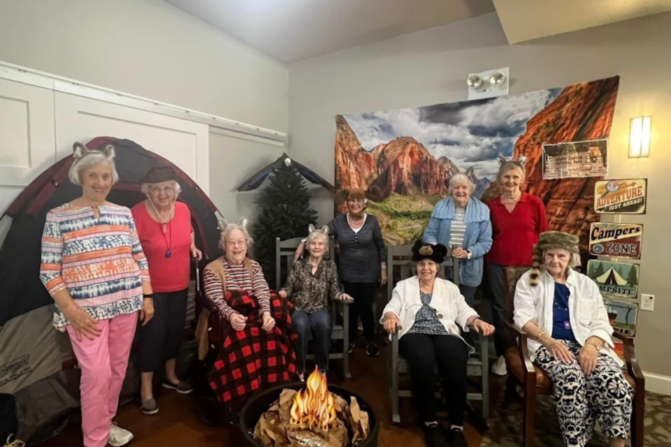 the-lodge-bethany-residents-at-a-national-park-event-in-front-of-the-fire-pit-wearing-animal-fur-hats-jerri-mathis