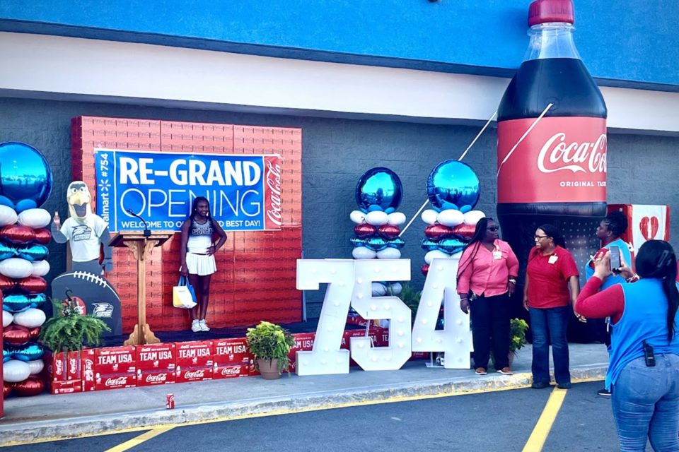 Wal-mart team members and customers celebrate the grand re-opening of the store