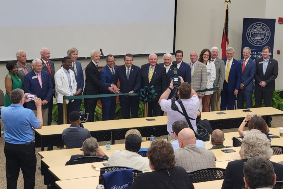 Paul Hinchey, Kyle Marrero, Russell Keen and Sonny Perdue (in center) join University and State leaders cutting the ribbon