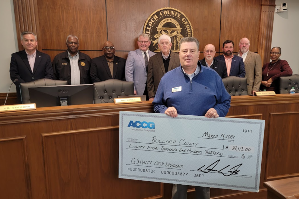 Commissioners accept a check from ACCG and appoint a new EMA Director ...