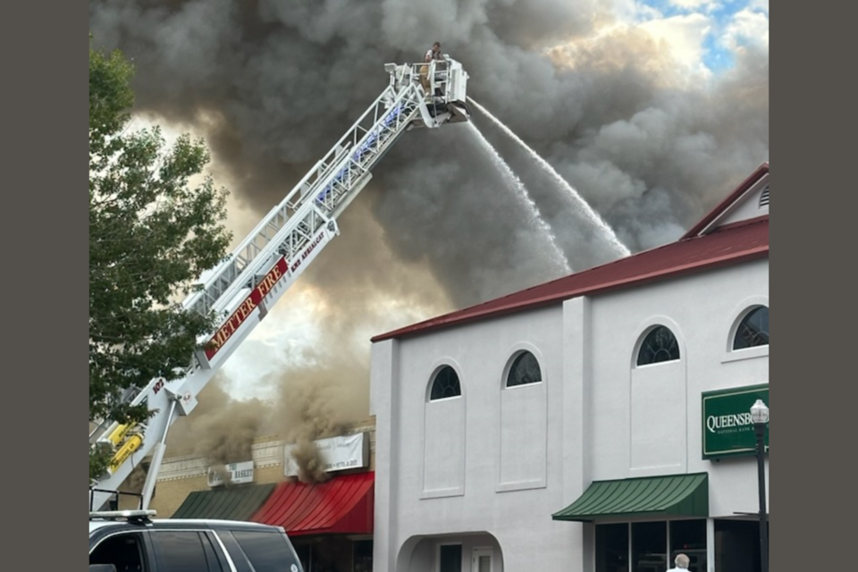 Tower truck puts water on Queensborough Bank building in downtown Metter