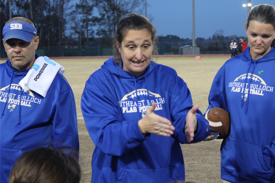 sebflagfb_-head-coach-marci-cochran-explaining-plays-to-her-team-during-halftime